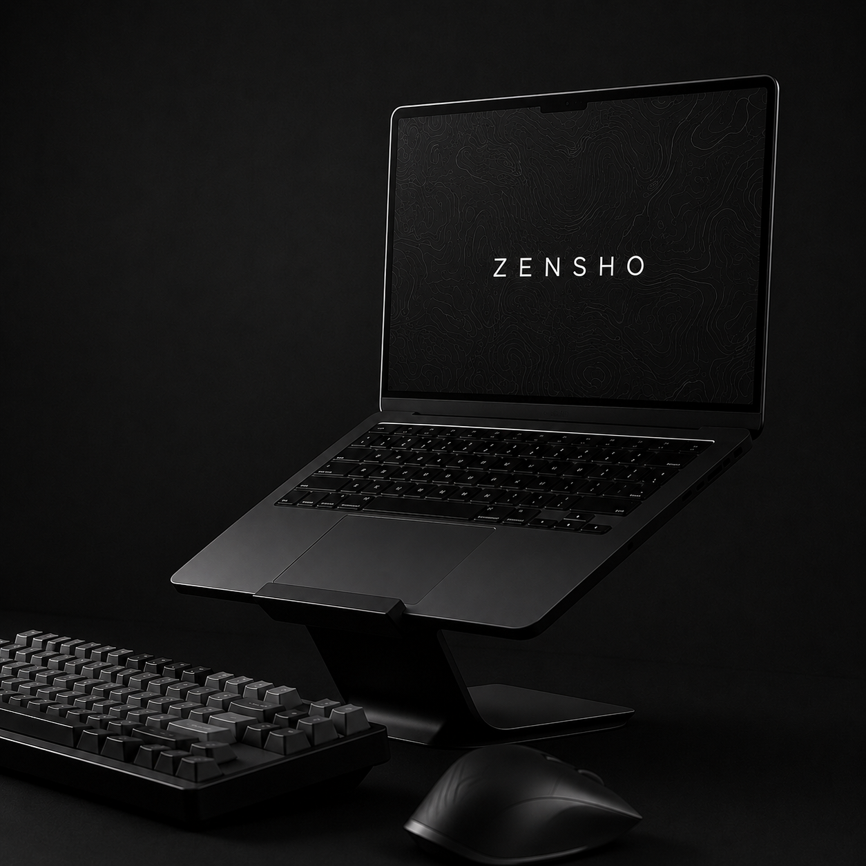 Blacked-out desk with laptop on an aluminium stand